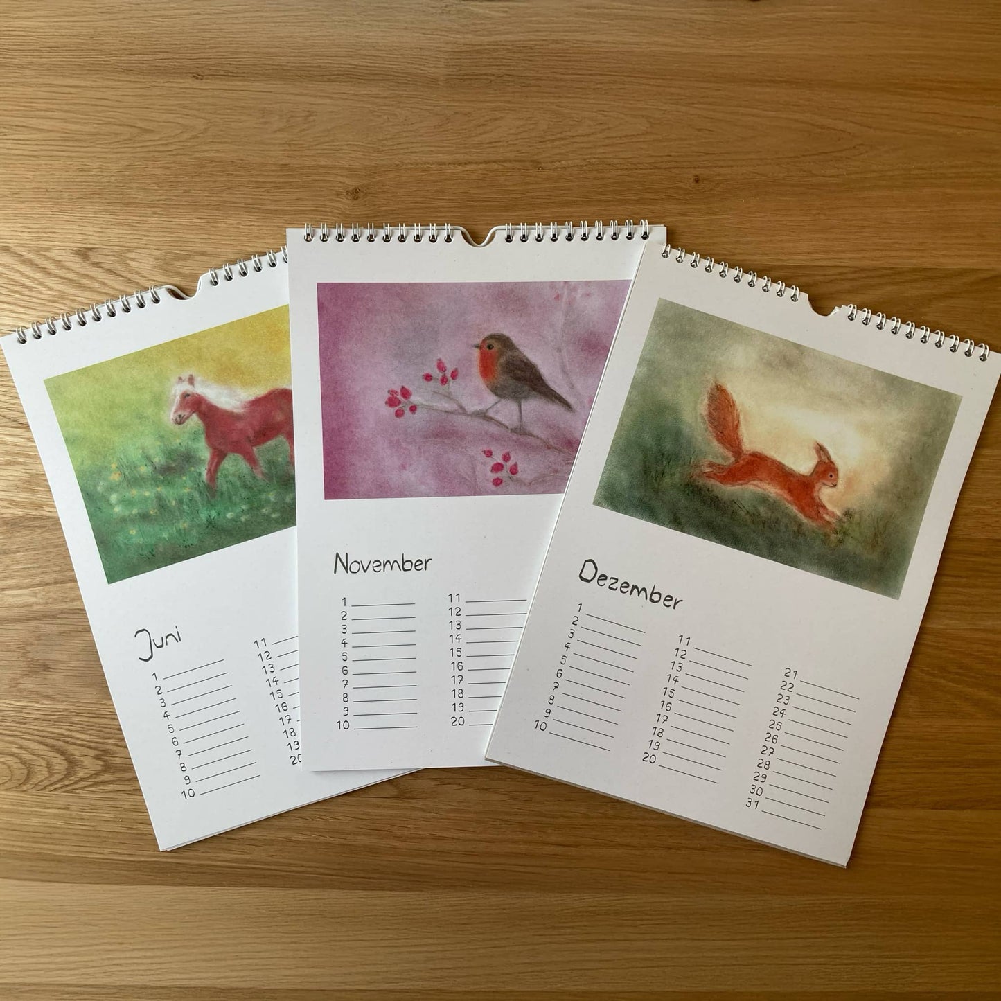 Perpetual animal calendar in Seccorell technique by Andrea Reiß with the monthly pages June (horse), November (robin) and December (fox).